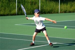 Child playing tennis